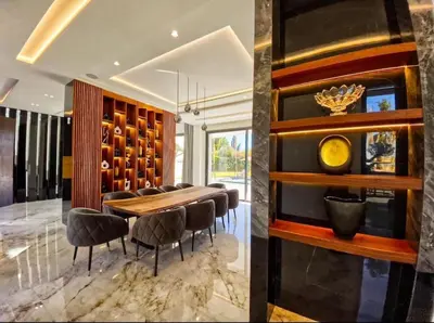 a dining room with a wooden table and chairs at Villa Beverly hills-luxury home in Marrakech