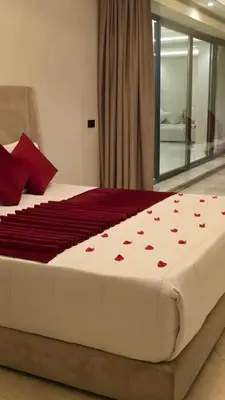 a bed with red hearts on it in a bedroom at bianca in Marrakech