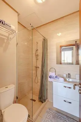 a bathroom with a shower and a toilet and a sink at New! Appt Moderne Jubaea avec parking & wifi in Marrakech