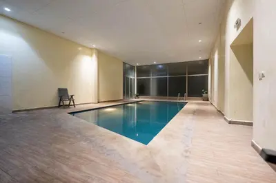 a large swimming pool in a large room at Hivernage by Louhou Collection in Marrakech
