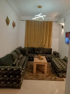 a living room with a couch and a coffee table at Abwab guilize Beautiful modern apartment in Marrakech