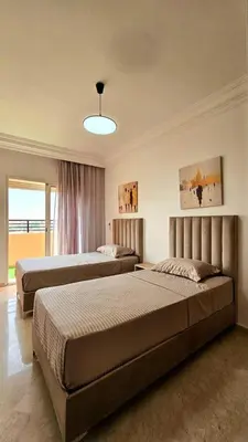 a bedroom with two beds and a large window at Welcome to Chya House! in Marrakech