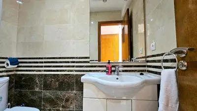 a bathroom with a sink and a mirror and a toilet at Welcome to Chya House! in Marrakech