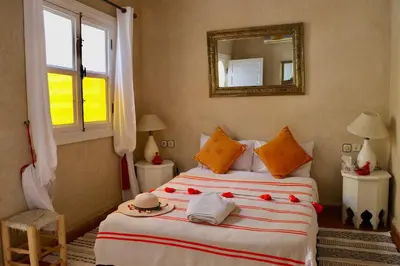 a bedroom with a bed with a hat and a mirror at Riad Chez moi in Marrakech