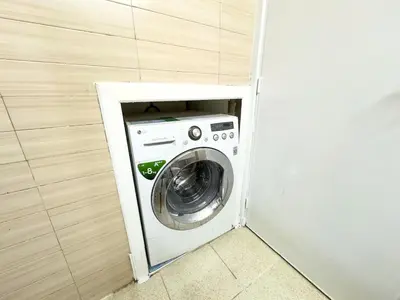 a washing machine in a corner of a room at Gueliz Marrakech Private 2BR Apartment with Pool and Parking in Marrakech