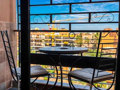 a table and two chairs on a balcony with a view at Gueliz Marrakech Private 2BR Apartment with Pool and Parking in Marrakech