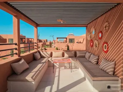 a patio with couches and a table on a building at Dar Zohra in Marrakech