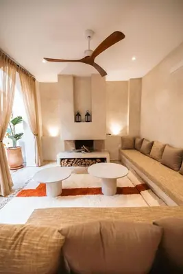 a living room with two tables and a couch at Riad Manah Marrakech - Ideal for groups & families in Marrakech