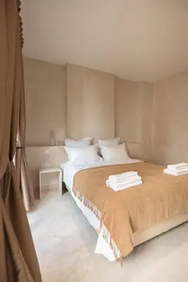 a bedroom with a large bed with towels on it at Riad Manah Marrakech - Ideal for groups & families in Marrakech