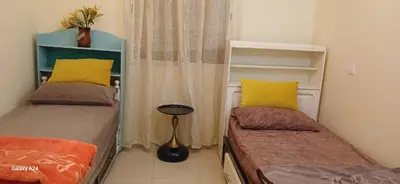 a small room with two beds and a window at Horizon Sérénité in Marrakech