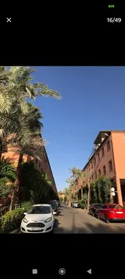 a white car parked on the side of a street at Riad Benhamou 3 in Marrakech