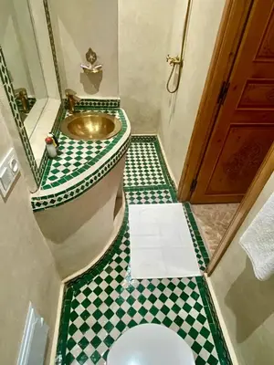 a bathroom with a sink and a toilet at Riad Rose Mati in Marrakech