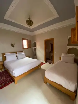 a bedroom with two beds and a ceiling at Riad Rose Mati in Marrakech