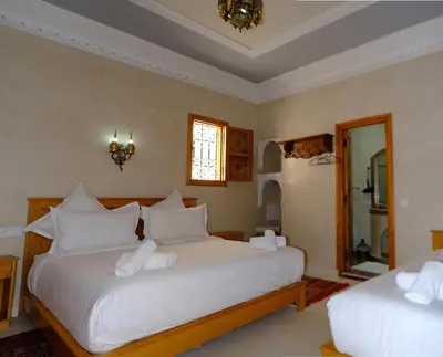 a bedroom with two beds with white pillows at Riad Rose Mati in Marrakech
