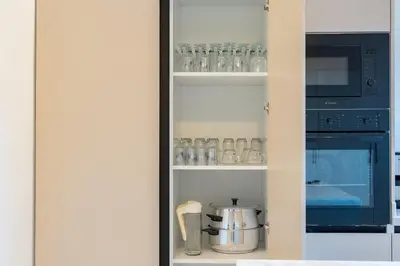 a kitchen with a pantry with glasses and a stove at Perfect Villa, Heated Pool, 15min from City Center, 4 Bedrooms, Private Cook and Airport Pickup in Marrakech