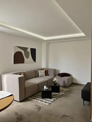 a living room with a couch and a table at Bohemian Chic Duplex Marrakech in Marrakech