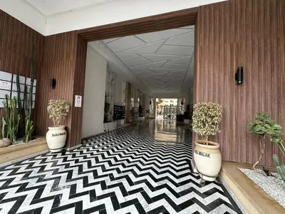a hallway with potted plants in a lobby at Duplexe super in Marrakech
