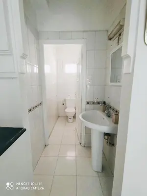 a white bathroom with a sink and a toilet at Top Location Gueliz Centre in Marrakech