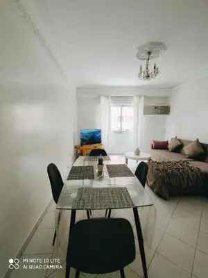 a living room with a table and a couch at Top Location Gueliz Centre in Marrakech
