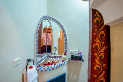a bathroom with a sink and a mirror at Riad Le Graff Pink in Marrakech