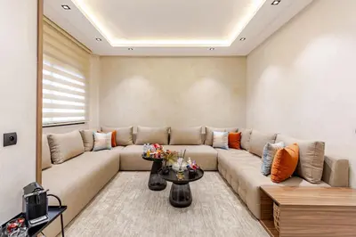 a living room with a large couch and a table at Design Calme Luxe Fibre Ultra-Rapide 2CH in Marrakech