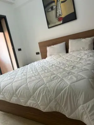 a bedroom with a white bed with a wooden headboard at Cozy Apartment With Pool 5 min from Guéliz in Marrakech