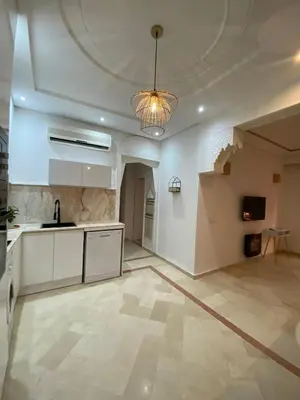 a large kitchen with a table and a ceiling at Gueliz ultra central & Cosy in Marrakech