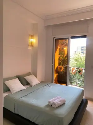 a bedroom with a large bed with two towels on it at Gueliz ultra central & Cosy in Marrakech