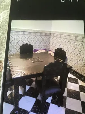 a table and a chair in a room at Riad shamekh in Marrakech