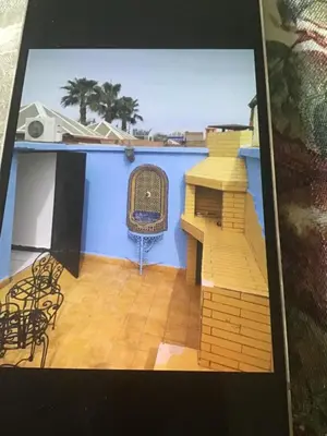 a view of a room with a blue wall and chairs at Riad shamekh in Marrakech