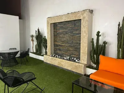 a living room with a fireplace and a table and chairs at Duplex 3 chambres centre ville in Marrakech