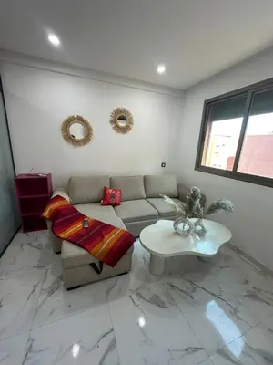 a living room with a couch and a table at chiimappart in Marrakech
