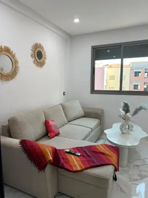 a living room with a couch and a table at chiimappart in Marrakech