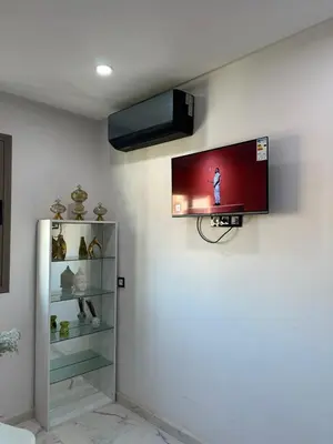 a flat screen tv hanging on a wall at chiimappart in Marrakech