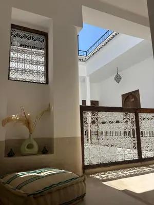 a room with a large window and a pillow at Riad julines in Marrakech