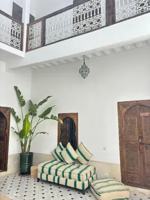 a living room with a couch and pillows on the floor at Riad julines in Marrakech