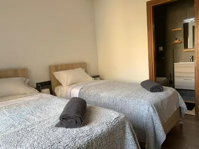 two beds in a room with towels on them at Appartement Mazal in Marrakech