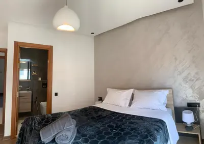 a bedroom with a large bed with white pillows at Appartement Mazal in Marrakech