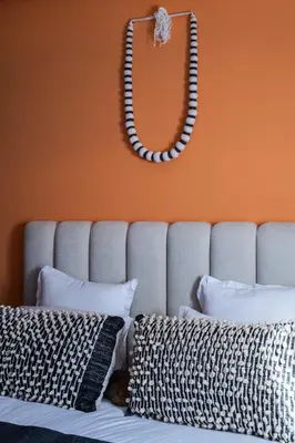 a mirror on the wall above a bed with pillows at Beldi garden - appartement avec jardin et gouvernante in Marrakech