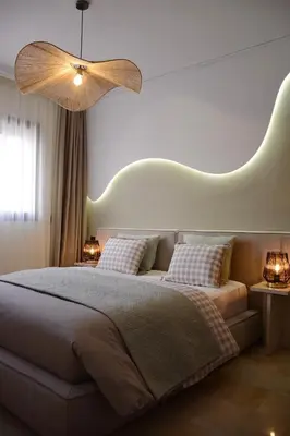 a bedroom with a large bed with two pillows at Appartement Cosy et Moderne Accès 4 piscines in Marrakech