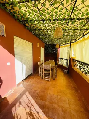 a dining room with a table and chairs at chic nest heart of gueliz With pool in Marrakech