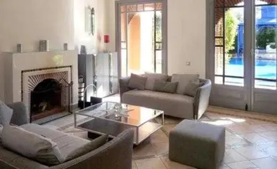 a living room with a couch and a fireplace at Luxury villa - AC- 5BR-11P- Palmeraie Marrakech in Marrakech