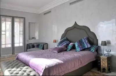 a bedroom with a large bed with purple sheets and pillows at Luxury villa - AC- 5BR-11P- Palmeraie Marrakech in Marrakech