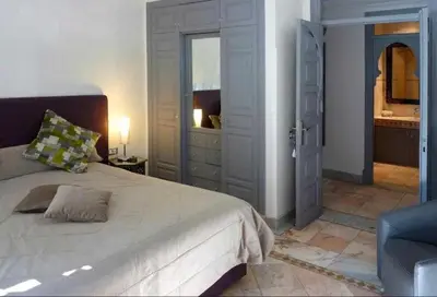 a bedroom with a large bed and a dresser at Luxury villa - AC- 5BR-11P- Palmeraie Marrakech in Marrakech