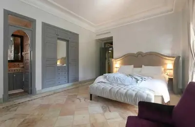 a bedroom with a large bed and a couch at Luxury villa - AC- 5BR-11P- Palmeraie Marrakech in Marrakech