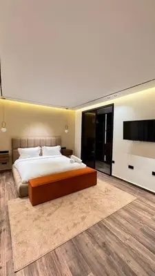 a bedroom with a large bed and a flat screen tv at villa Argan, Confort & Modern avec PiscineChauffée in Marrakech