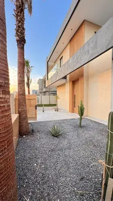 a courtyard with palm trees and a building at villa Argan, Confort & Modern avec PiscineChauffée in Marrakech