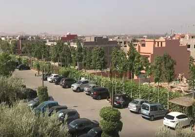 a parking lot with a bunch of cars parked at Luxueuse Appart Vizir 106 in Marrakech