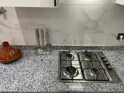 a stove top oven sitting on top of a counter at Modern Stay 3 bedroom City Center with Balcony in Marrakech