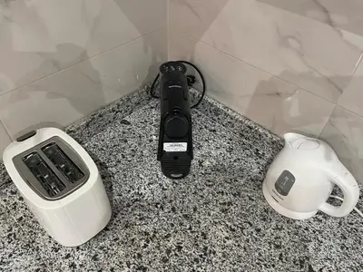 a phone and a hair dryer on a counter at Modern Stay 3 bedroom City Center with Balcony in Marrakech